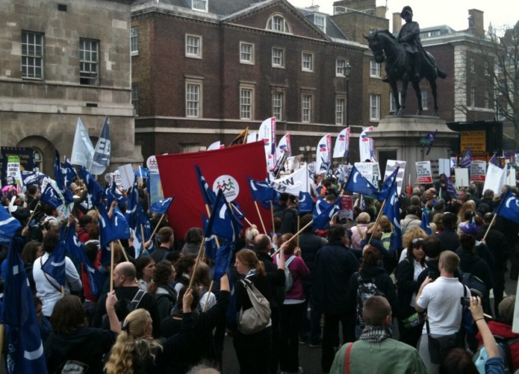 Protesters march down Whitehall during the March for the Alternative