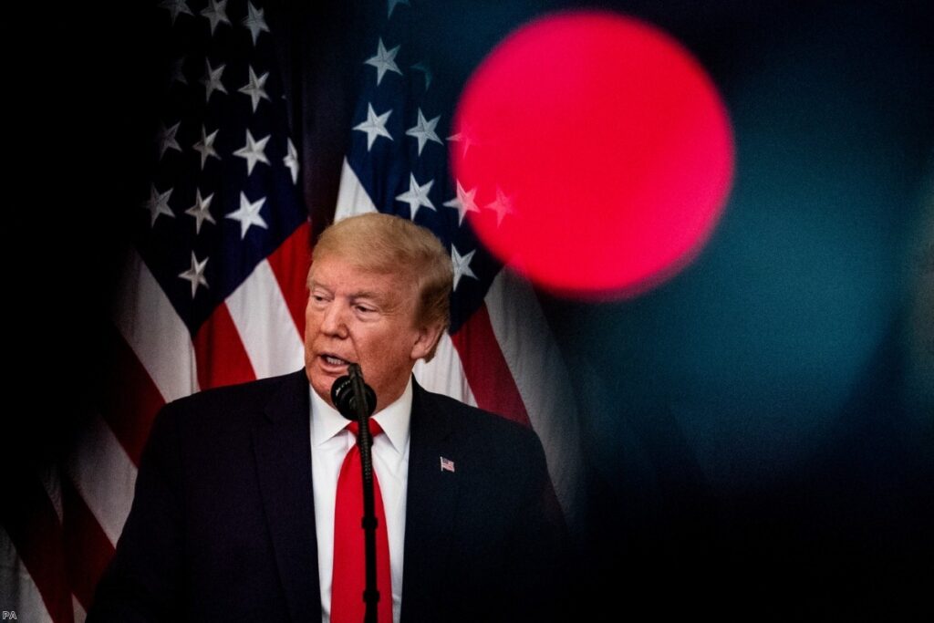 Donald Trump participates in a ceremony at the White House for volunteers during the pandemic.