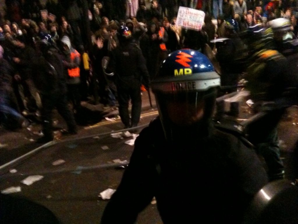 A policeman reacts to one of the skirmishes on Whitehall