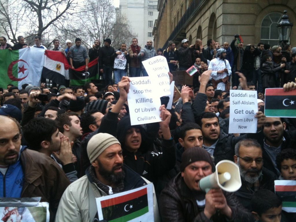 Libya protestors urge action from London in the days before intervention. The public is split on the choice to intervene in the country.