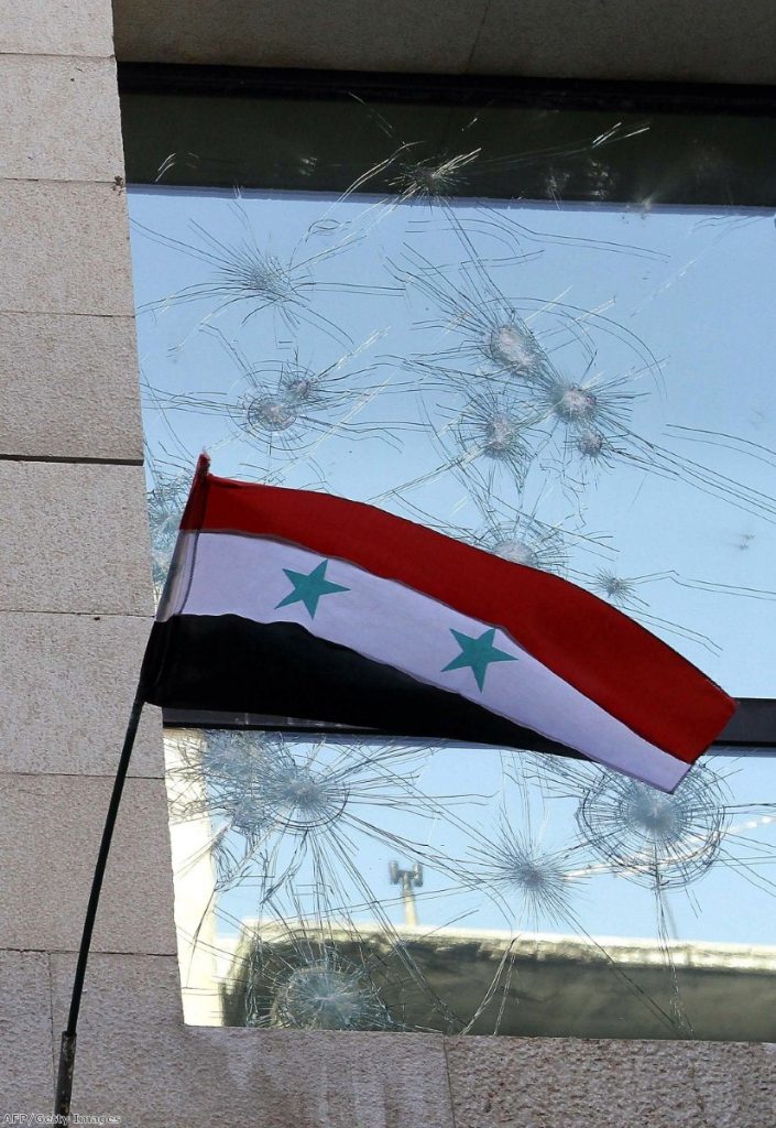 A shattered country: The Syrian flag flies after a Damascus protest