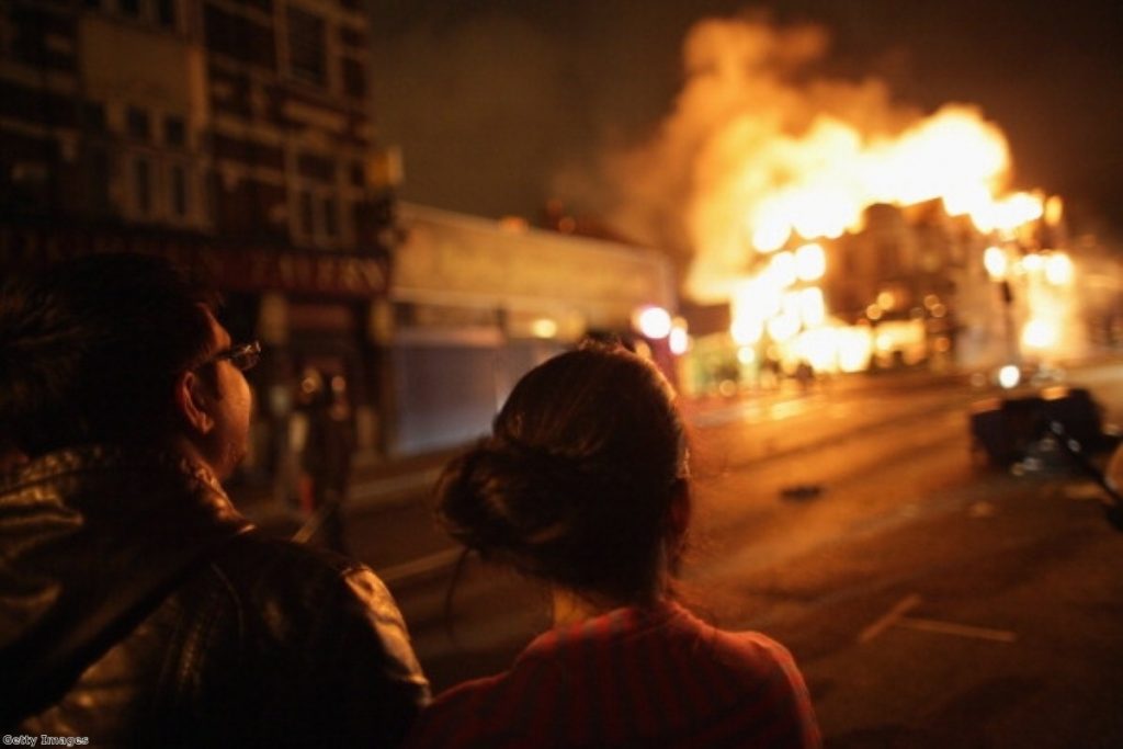 A couple looks on during the rioting earlier this week