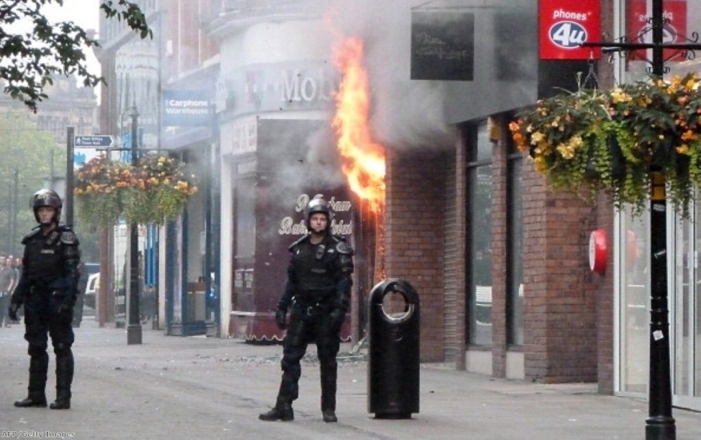 A fire rips through a shopping mall in Manchester during the height of the riots.