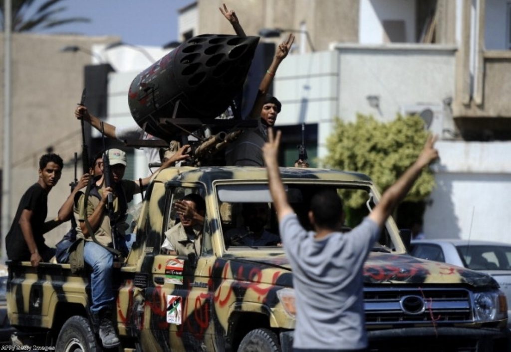 Rebel fighters celebrate in Tripoli. The Commons was less animated