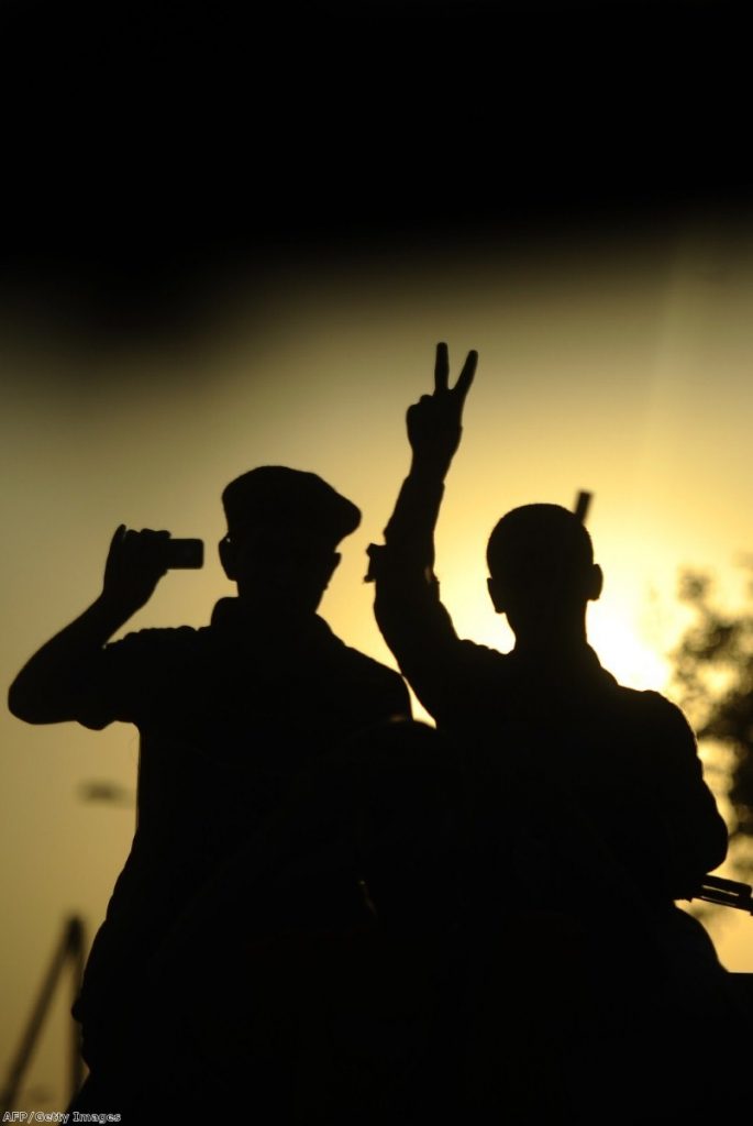 A rebel flashes the V-sign for victory during celebrations in the newly named Martyr