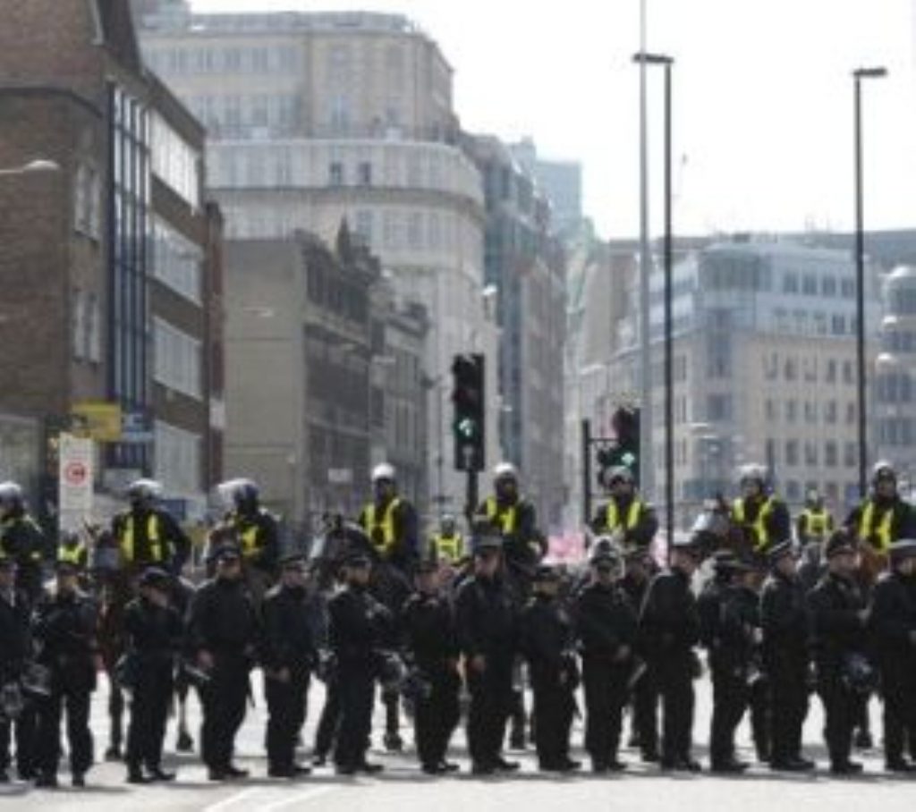 Police officers block a road in east London yesterday as the EDL gathered.