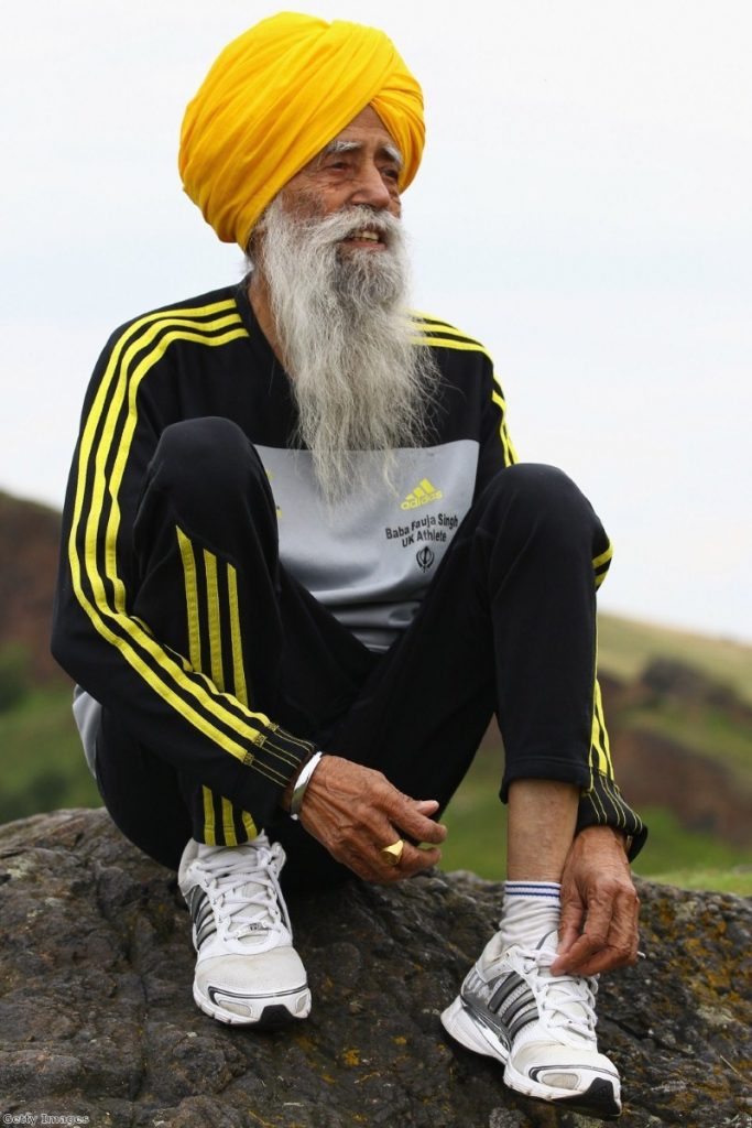 One hundred year old runner Fauja Singh, a Sikh, poses for pictures after being the first person to enter for 2012's Edinburgh Marathon.