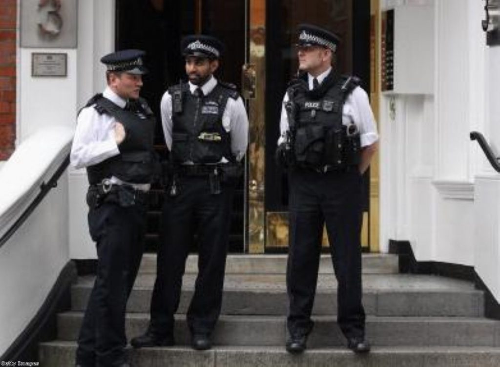 Police officers continue their long wait for Julian Assange outside Ecuador