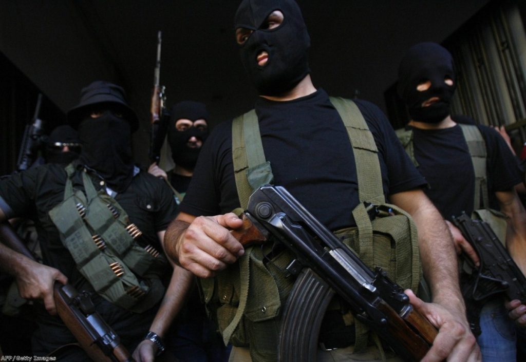 Lebanese masked gunmen from the al-Muqdad clan ready to speak to the press in Beirut