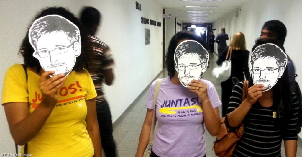 Members of the Youngs Together activist group pose with masks of Edward Snowden during a public hearing of Brazil-based Guardian reporter Glenn Greenwald at the Brazilian Senate