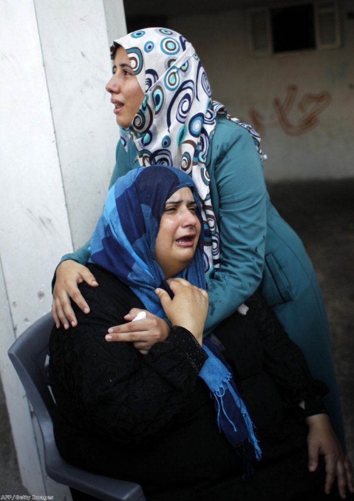 Relatives mourn during a funeral of at least nine members of the same al-Ghul family who died after their house was hit by an Israeli air strike yesterday