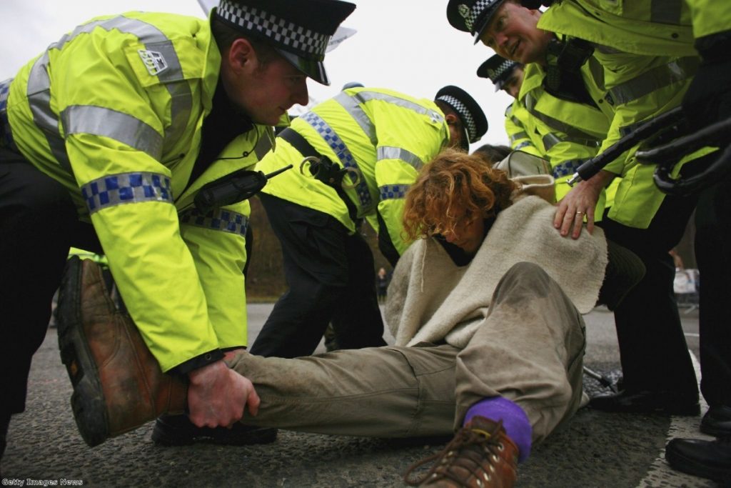 A campaigner is arrested during a protest at the Faslane naval base on the Clyde, home of Trident, in 2007.