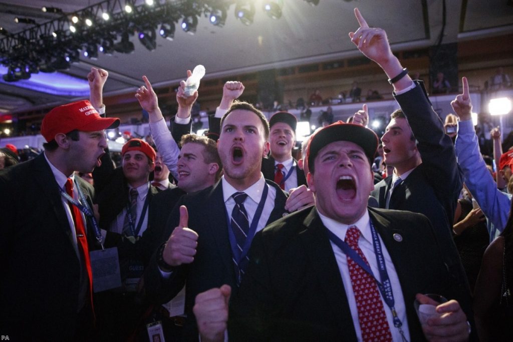 Supporters of Donald Trump cheer as they watch election results coming in
