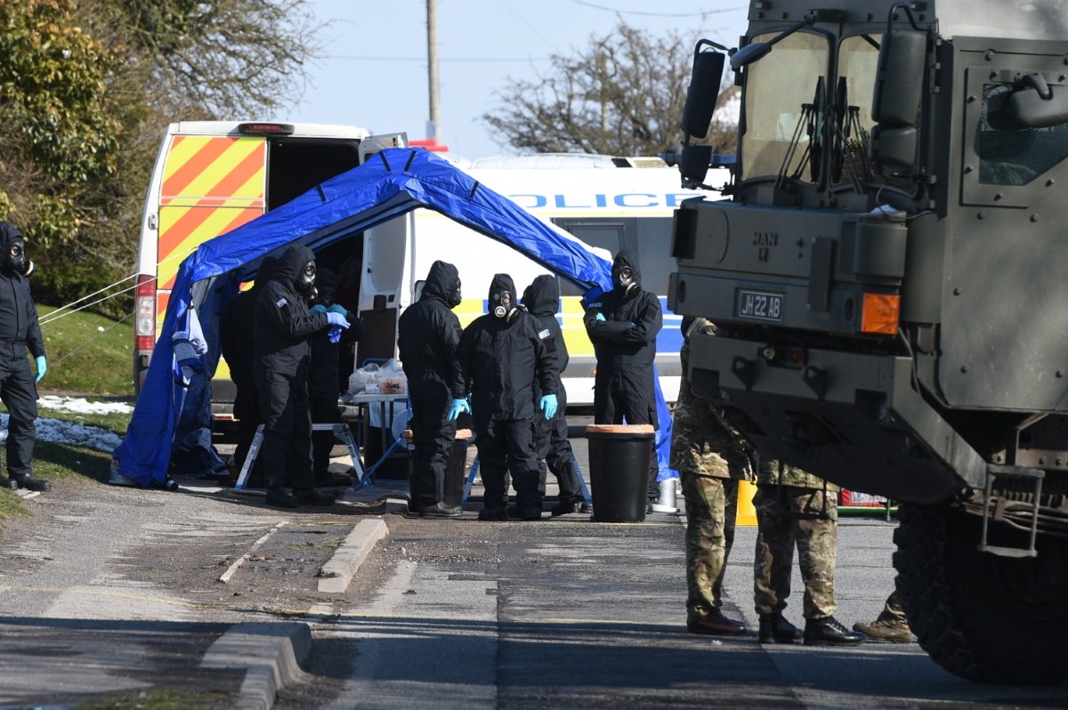 Police and army personnel suit up on Larkhill Road in Durrington, Salisbury, during the investigation into the attack on Sergei and Yulia Skripal