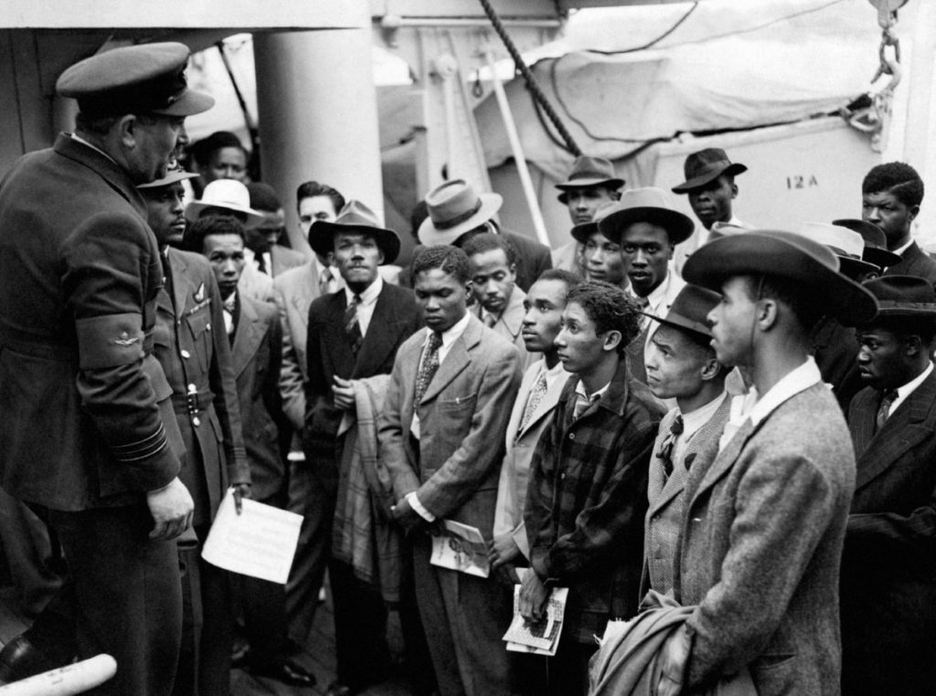 Jamaican immigrants are welcomed by RAF officials in 1948 as they arrive at Tilbury.