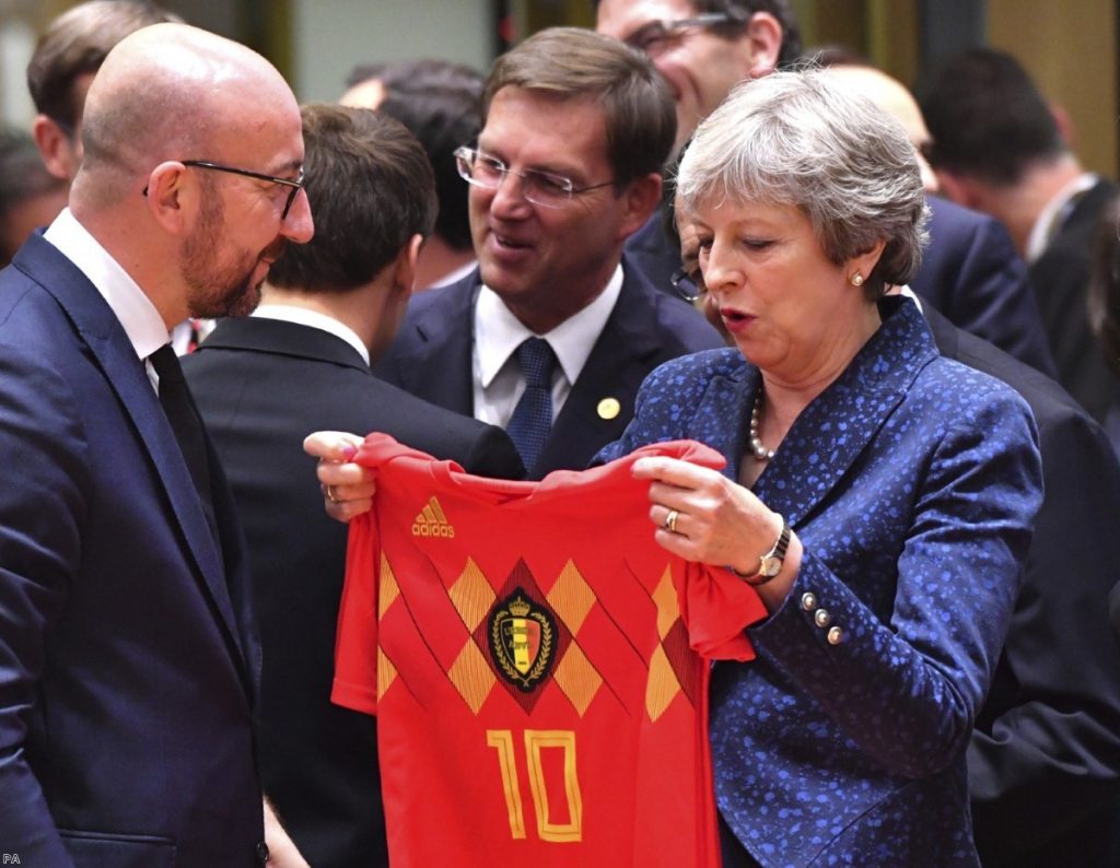 Charles Michel presents a Belgian team jersey to Theresa May during EU summit in Brussels | Copyright: PA