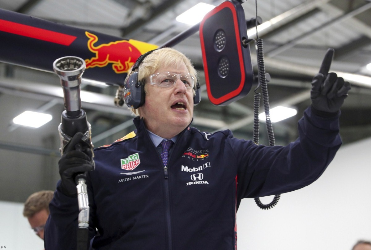 Boris Johnson prepares to change a wheel during a visit to Red Bull Racing facility in Milton Keynes. He has been accused of lying and evasiveness during the campaign.