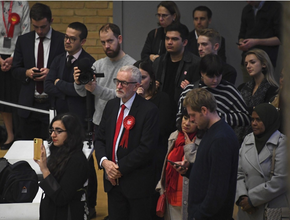 Jeremy Corbyn and his wife Laura Alvarez wait for the declaration of his seat as Labour seats fell across the country.