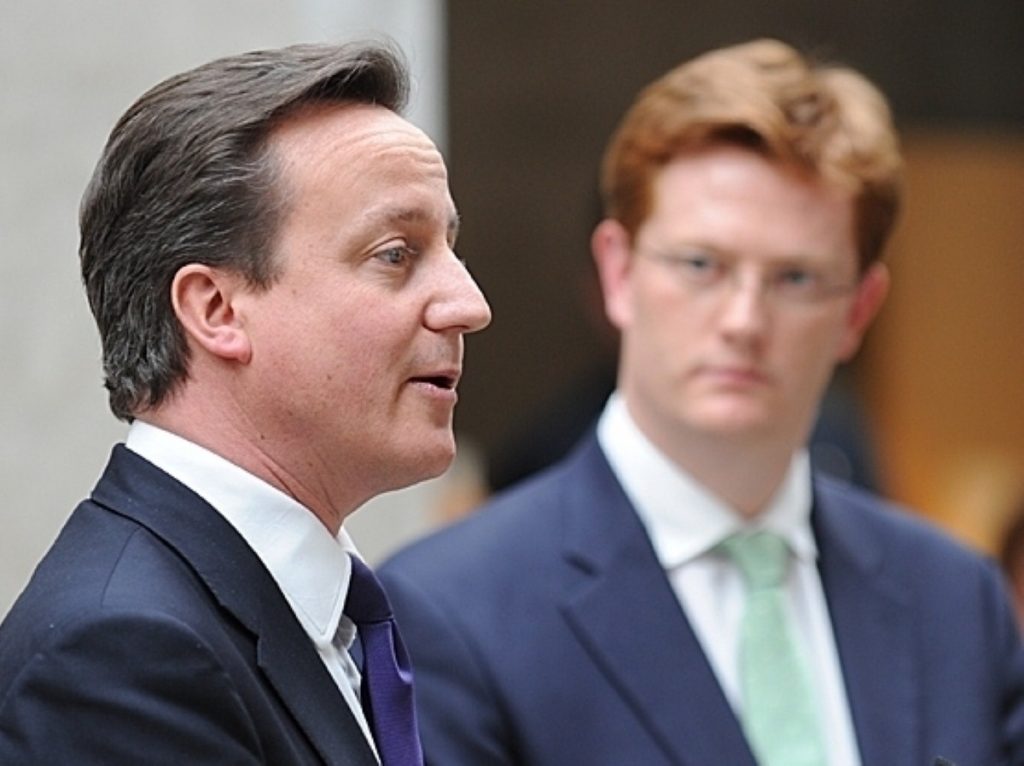 Danny Alexander looks on as David Cameron gives a speech