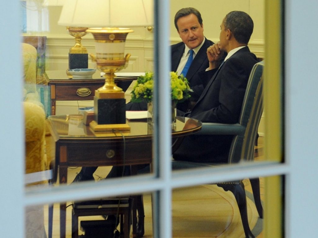 David Cameron listens intently during talks with Barack Obama today