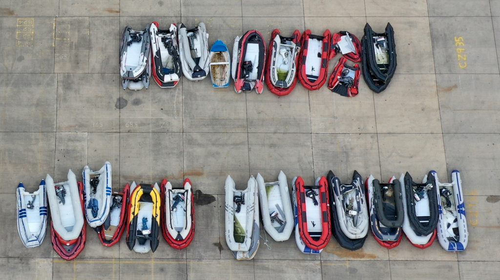 A view of small boats thought to be used in migrant crossings across the Channel at a storage facility in Dover, Kent.