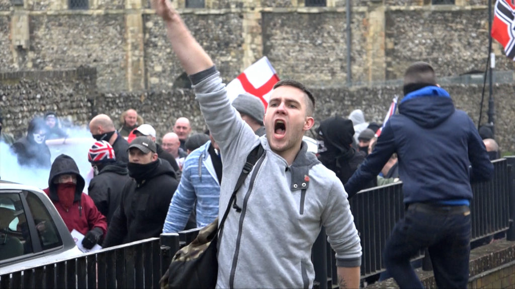 A member of the British far-right gives a Nazi salute