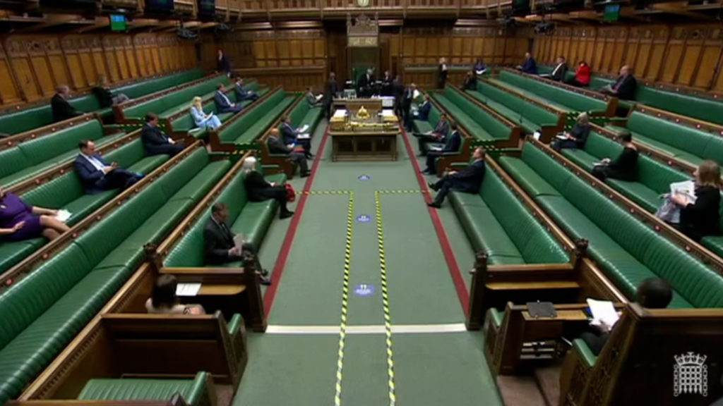 MPs sitting socially distanced in the House of Commons