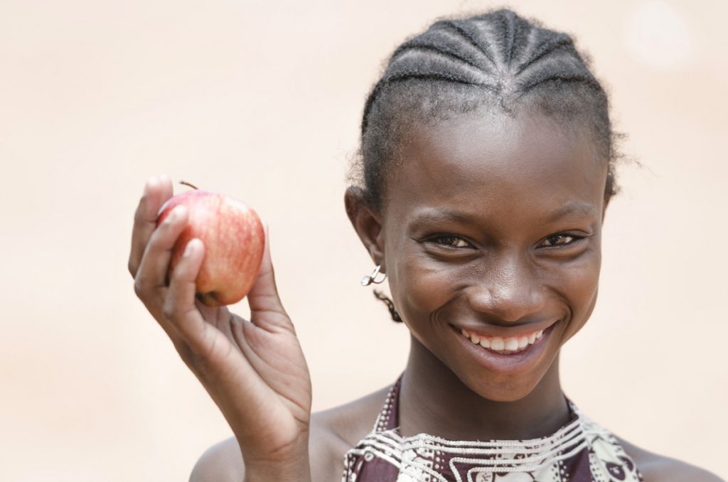 Vitality Healthy Eating Symbol: Smiling Young African Ethnicity Girl Apple