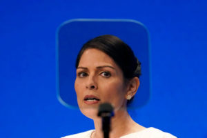 Britain's Home Secretary Priti Patel looks at a teleprompter as she speaks at the Conservative Party Conference in Manchester, England, Tuesday, Oct. 5, 2021. (AP Photo/Jon Super)