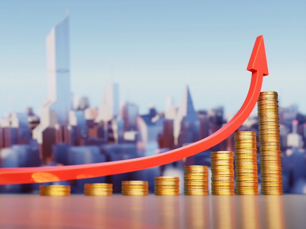 Inflation, prices rise concept. Coin stacks and red arrows representing the increase in the cost of living.