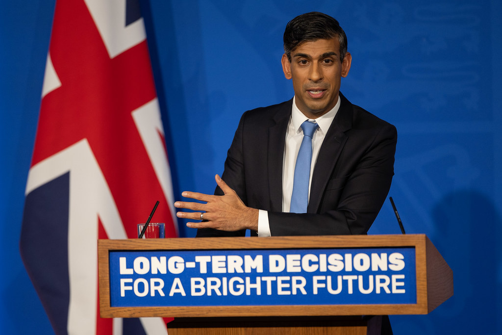 Rishi Sunak standing delivering a speech at the Downing Street press room.