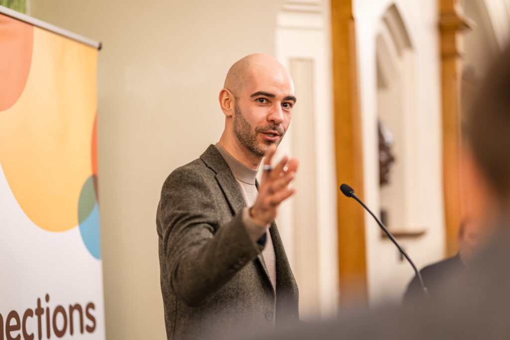 Leon Emirali speaking at an event in the Palace of Westminster